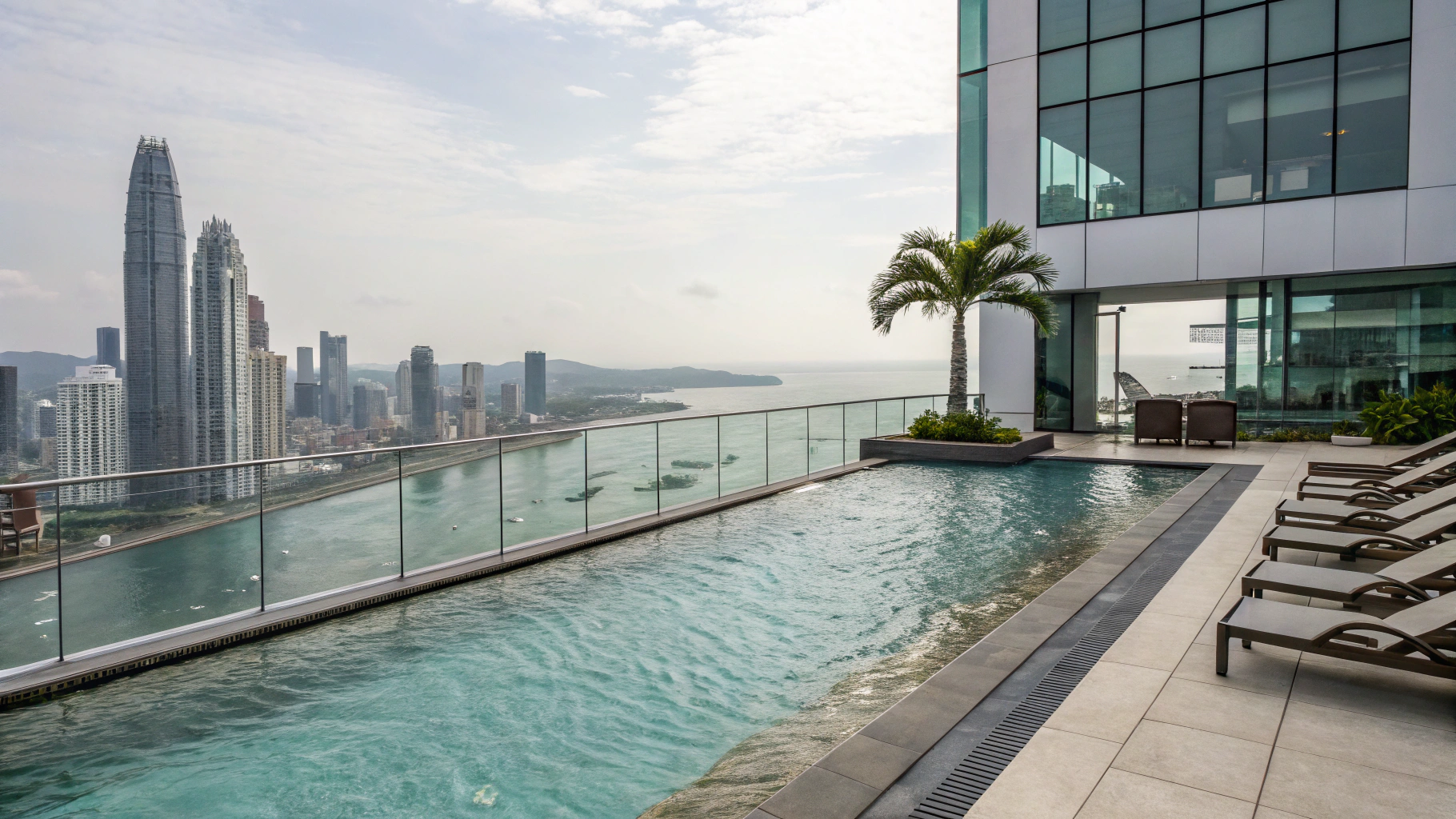 Outdoor infinity pool with stone deck and architectural ambient lighting